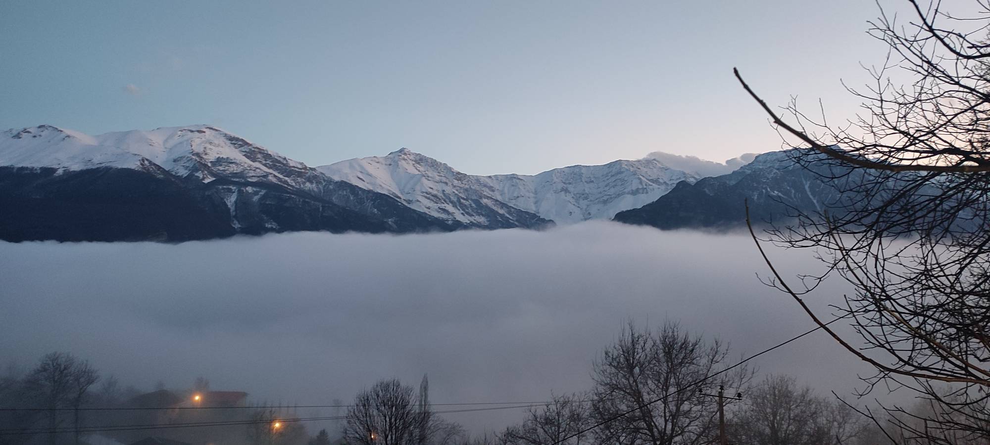 A sea of clouds landscape with snowy mountains